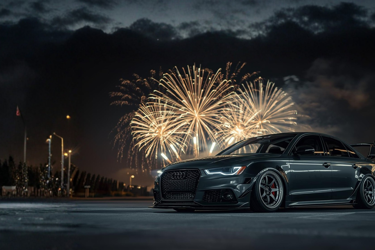 Car on a road with fireworks in the background